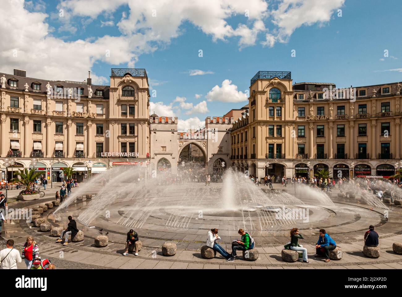 Munich, Germany, July 08, 2009: some people in front of Karl' s place and around his fountain Stock Photo