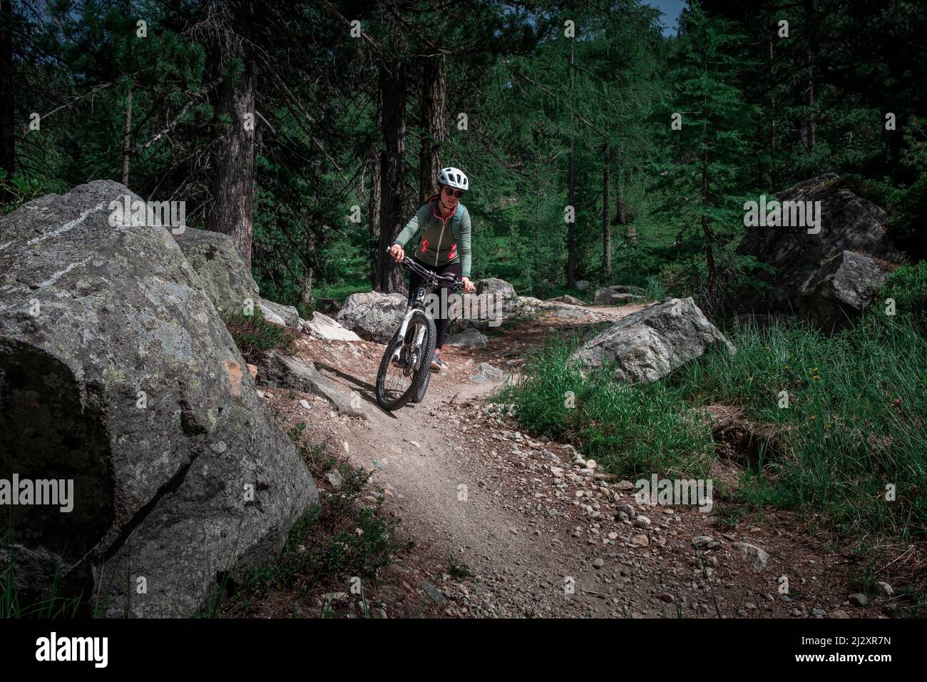 Mountain biking on the Bernina Express trail route from the Lago Bianco reservoir to Morteratsch Stock Photo