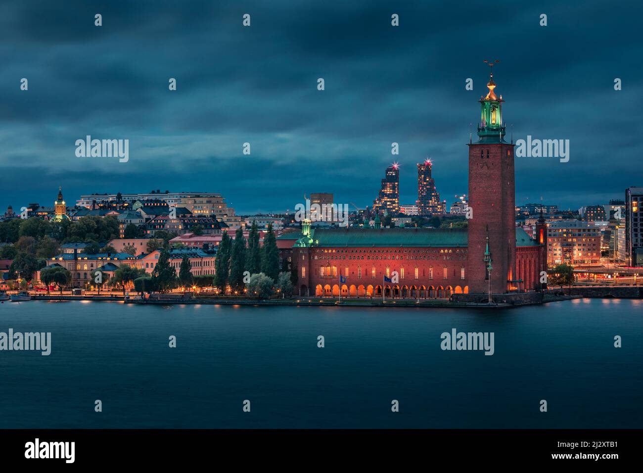 Illuminated Stockholm skyline at night with Stadshus in Sweden Stock Photo