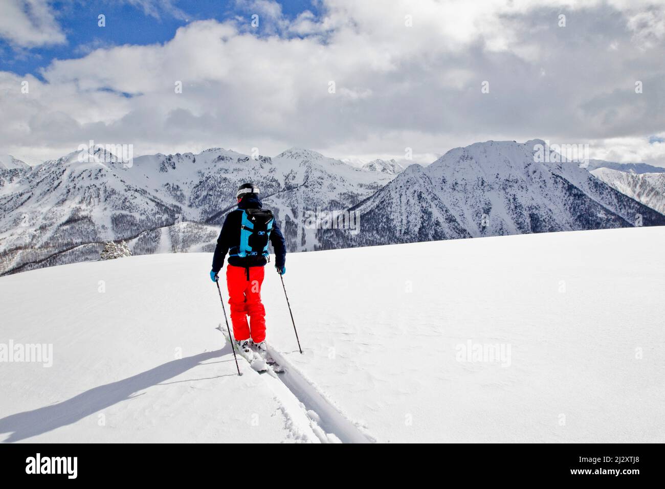 Ski resort of Montgenevre (French Alp, south-eastern France): man, freeride skier skiing in powder snow, off-piste skiing, backcountry skiing and trac Stock Photo