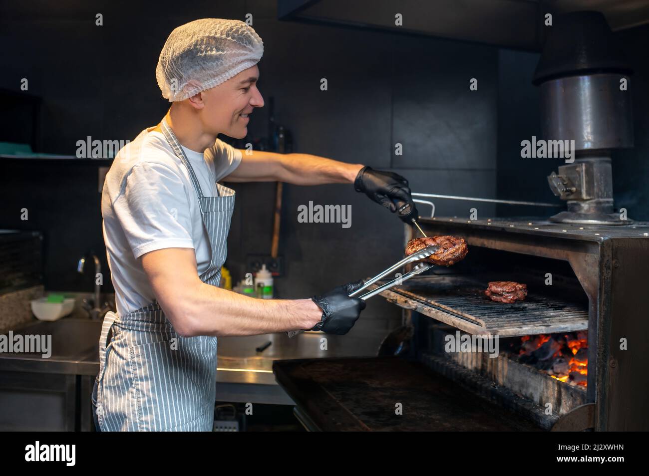 A chiefcooker working in the kitchen in the restaurant Stock Photo Alamy
