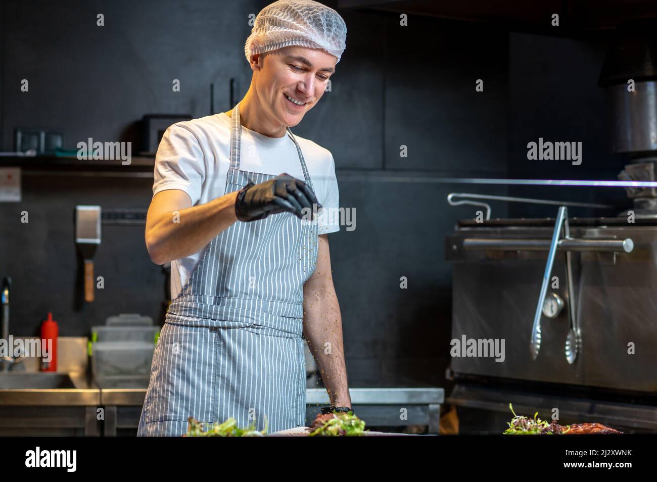 A chief-cooker cooking in the kitchen in the restaurant Stock Photo - Alamy
