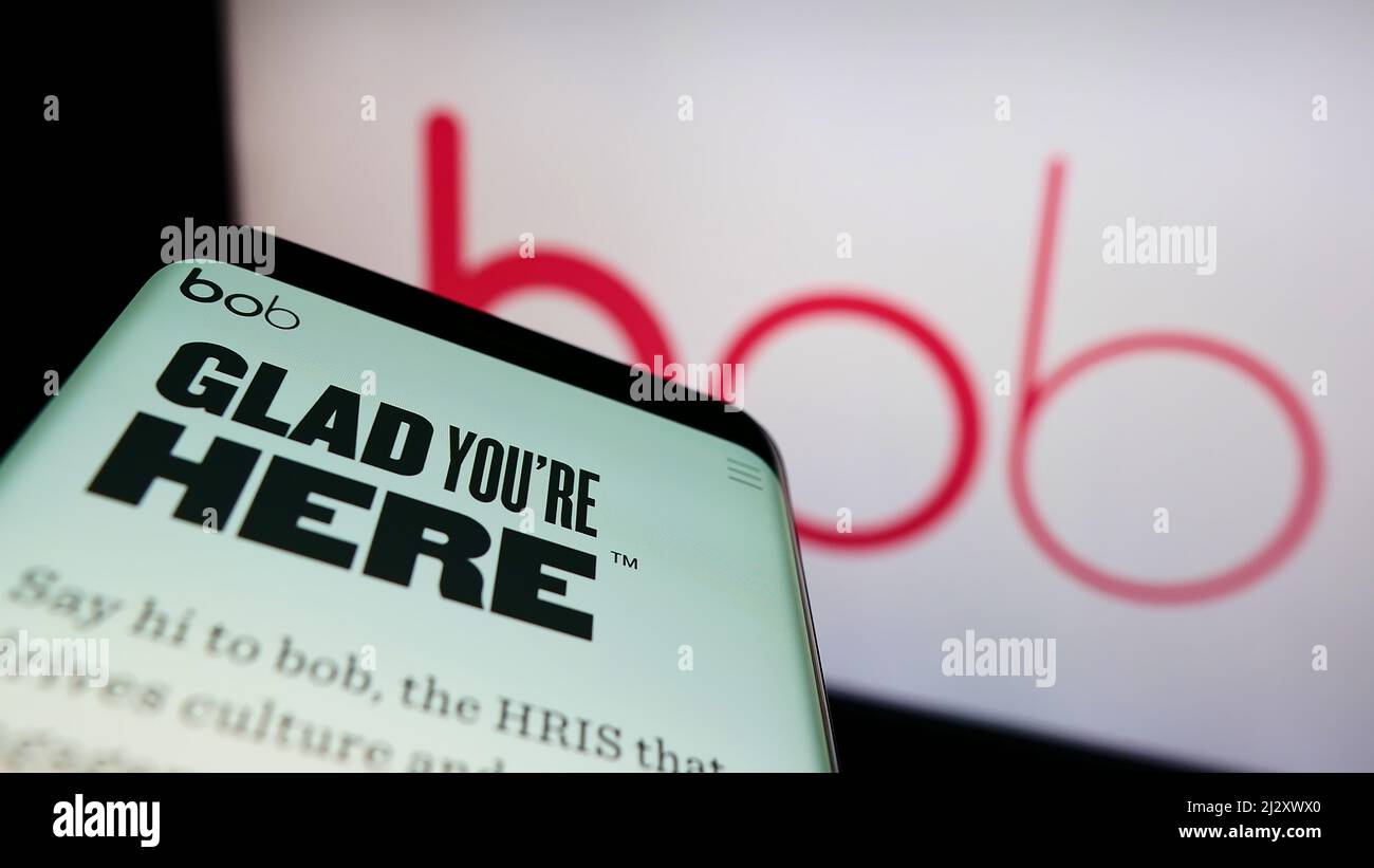 Mobile phone with website of HR software company Hi Bob Limited (HiBob) on screen in front of