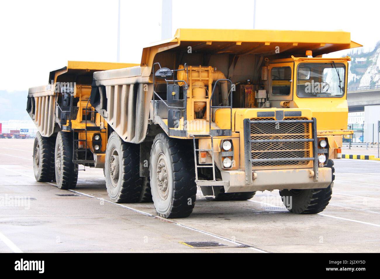 Quarry Trucks. Supersized haul trucks specifically engineered for use in quarries, mining and heavy-duty construction. Stock Photo
