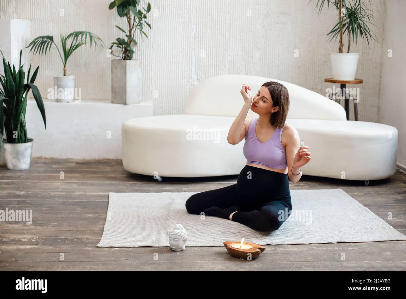 Calm pregnant woman using aromatherapy. Oil aromatic perfumes made of