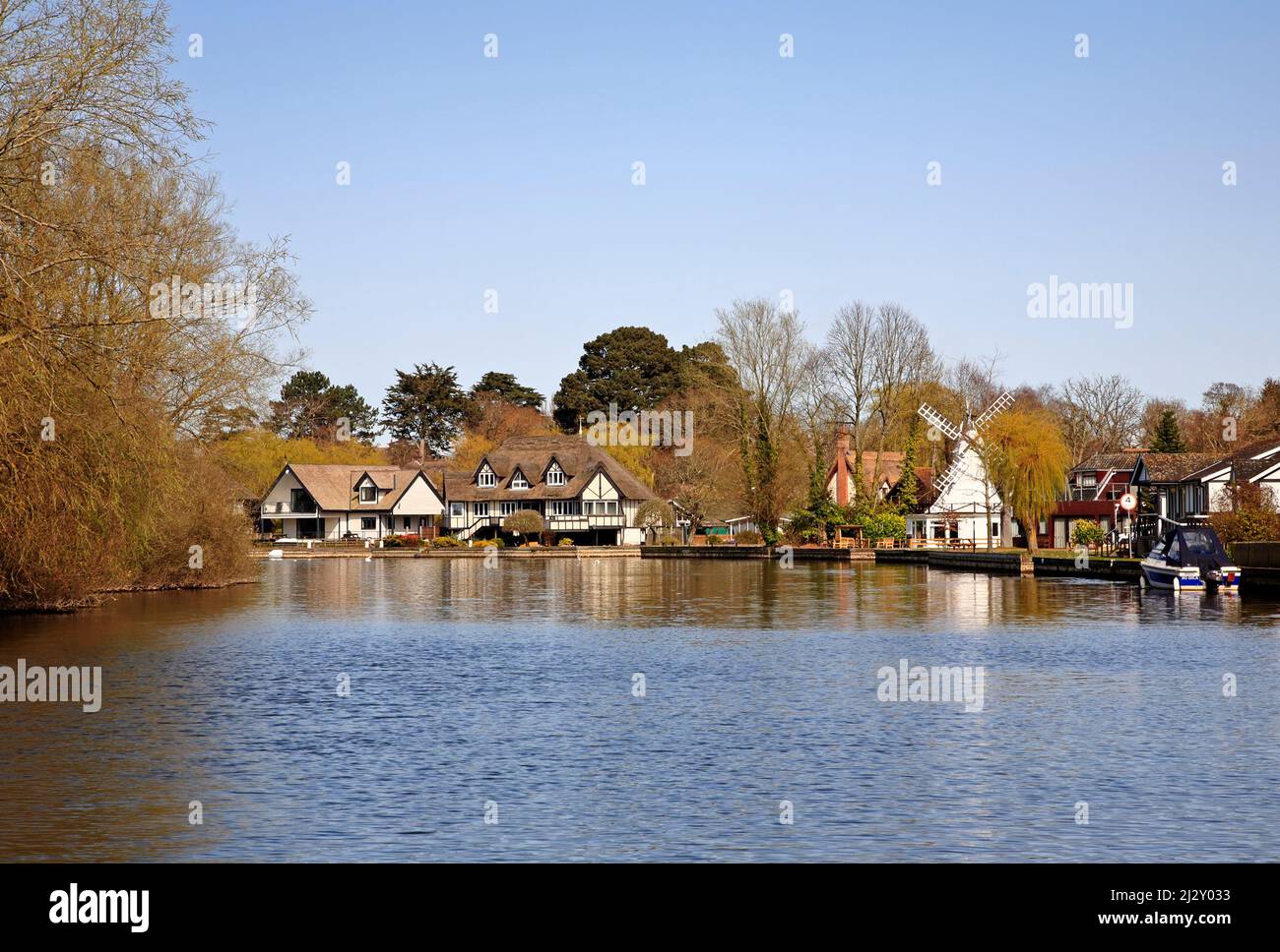 A view of the River Bure on the Norfolk Broads with desirable riverside properties at Horning