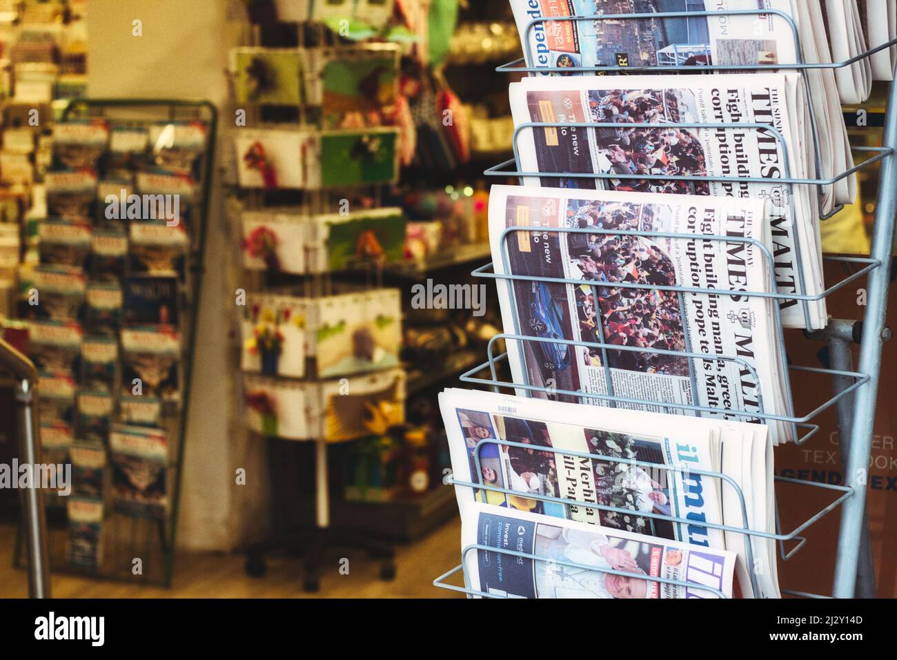 Malta - 03/04/2022: Maltese newspapers in a vertical rack outside a shop Stock Photo