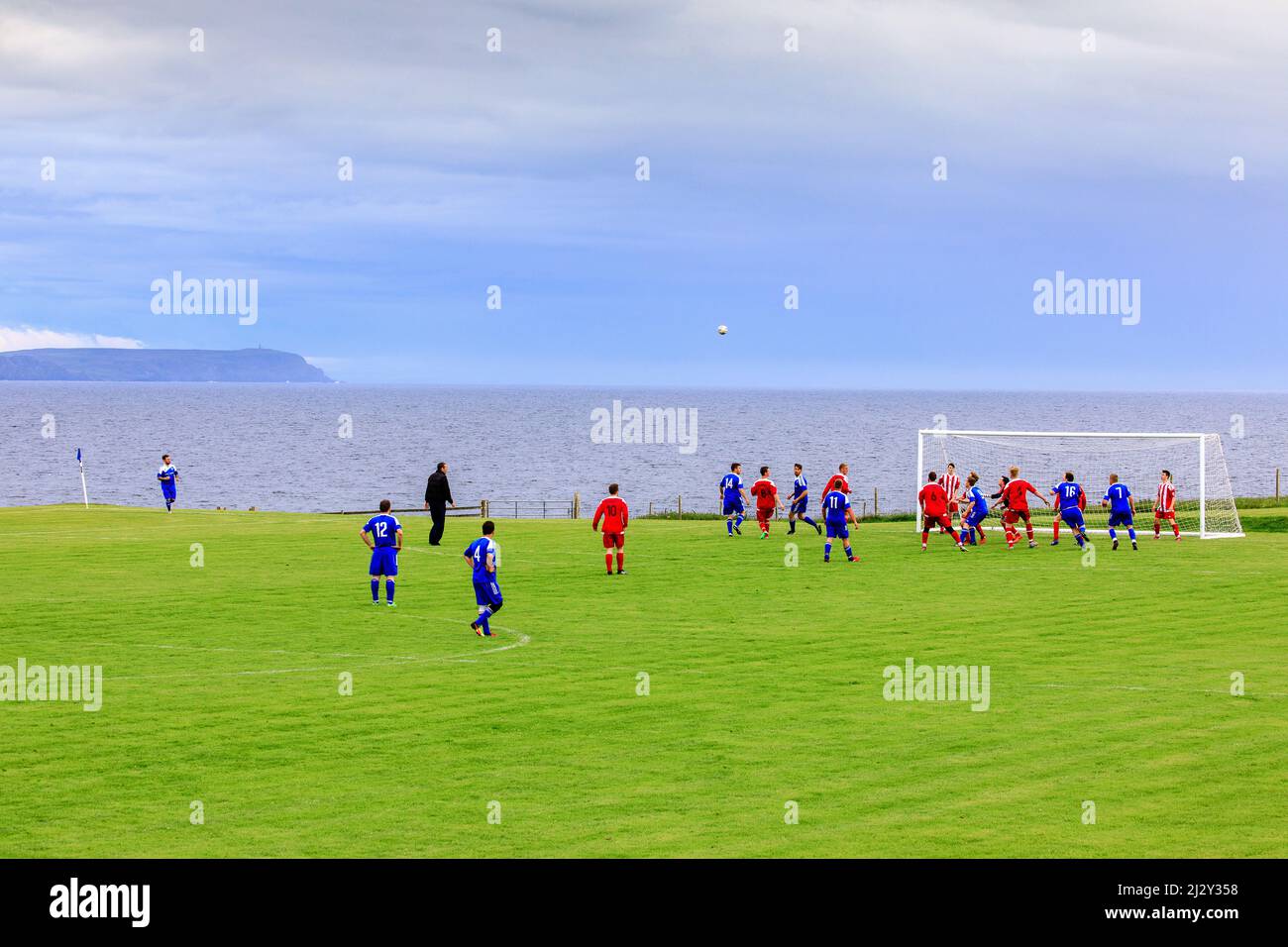 Football players in front of the sea, Port Charlotte, Islay, Inner Hebrides, Scotland UK Stock Photo