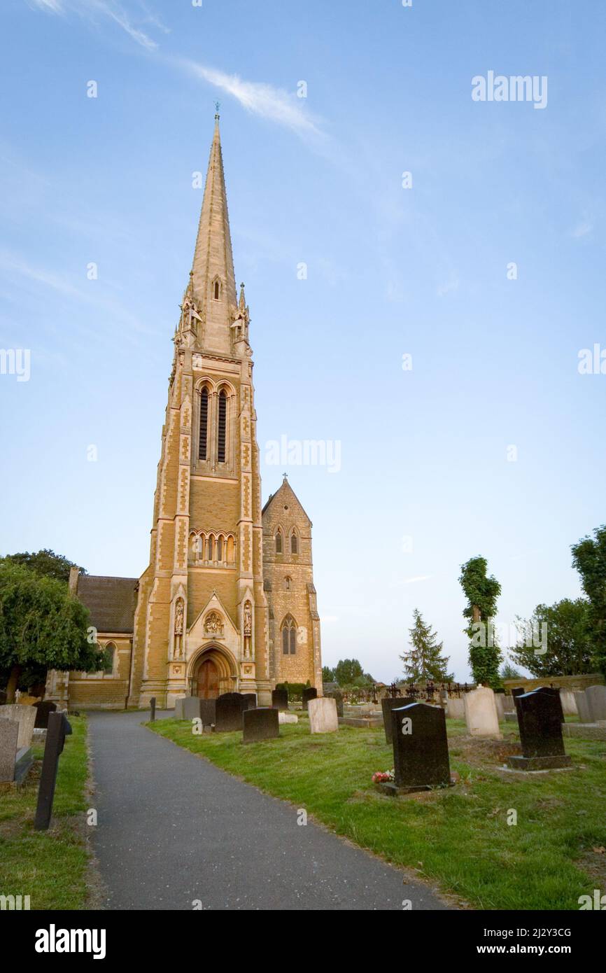 Traditional English Church. A view of a typical English spired church with its surrounding cemetery. Stock Photo
