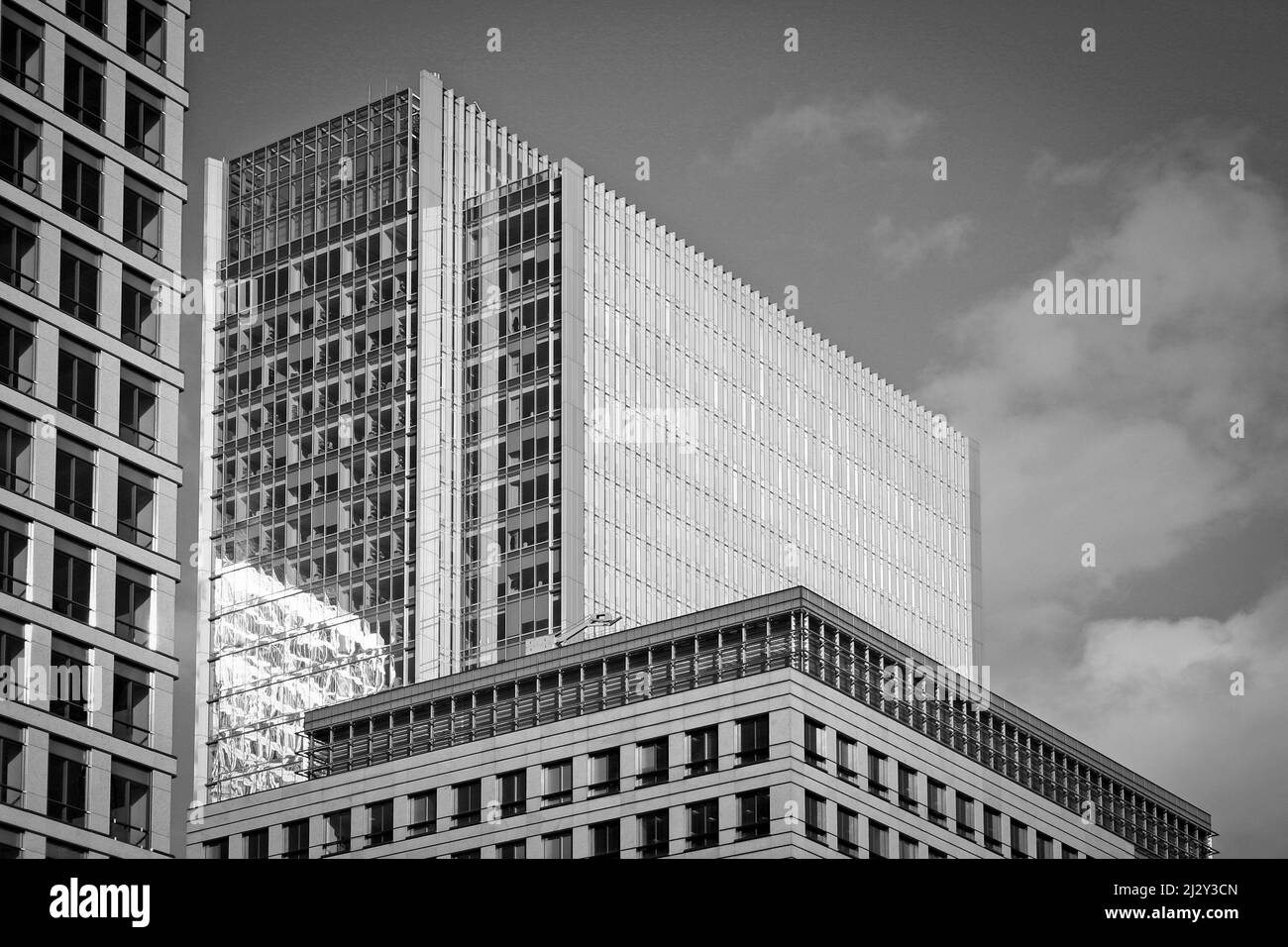 Abstract, full-frame modern business buildings.  Black and white with film grain added. Stock Photo