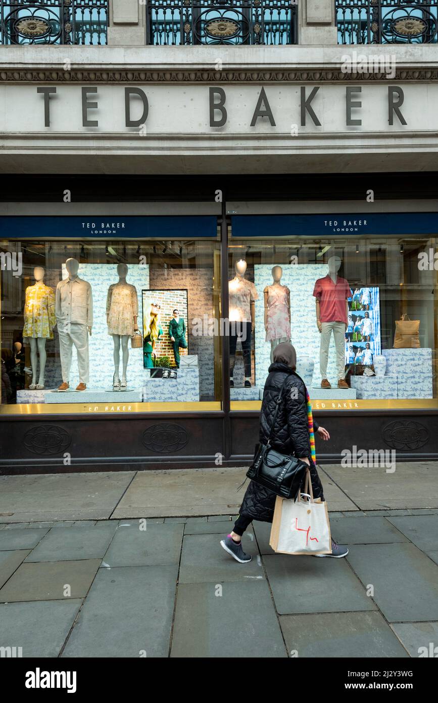 London, UK. 4 April 2022. A woman passes a branch of Ted Baker in Regent  Street. Shares in the fashion brand have risen after it announced that it  has begun a formal