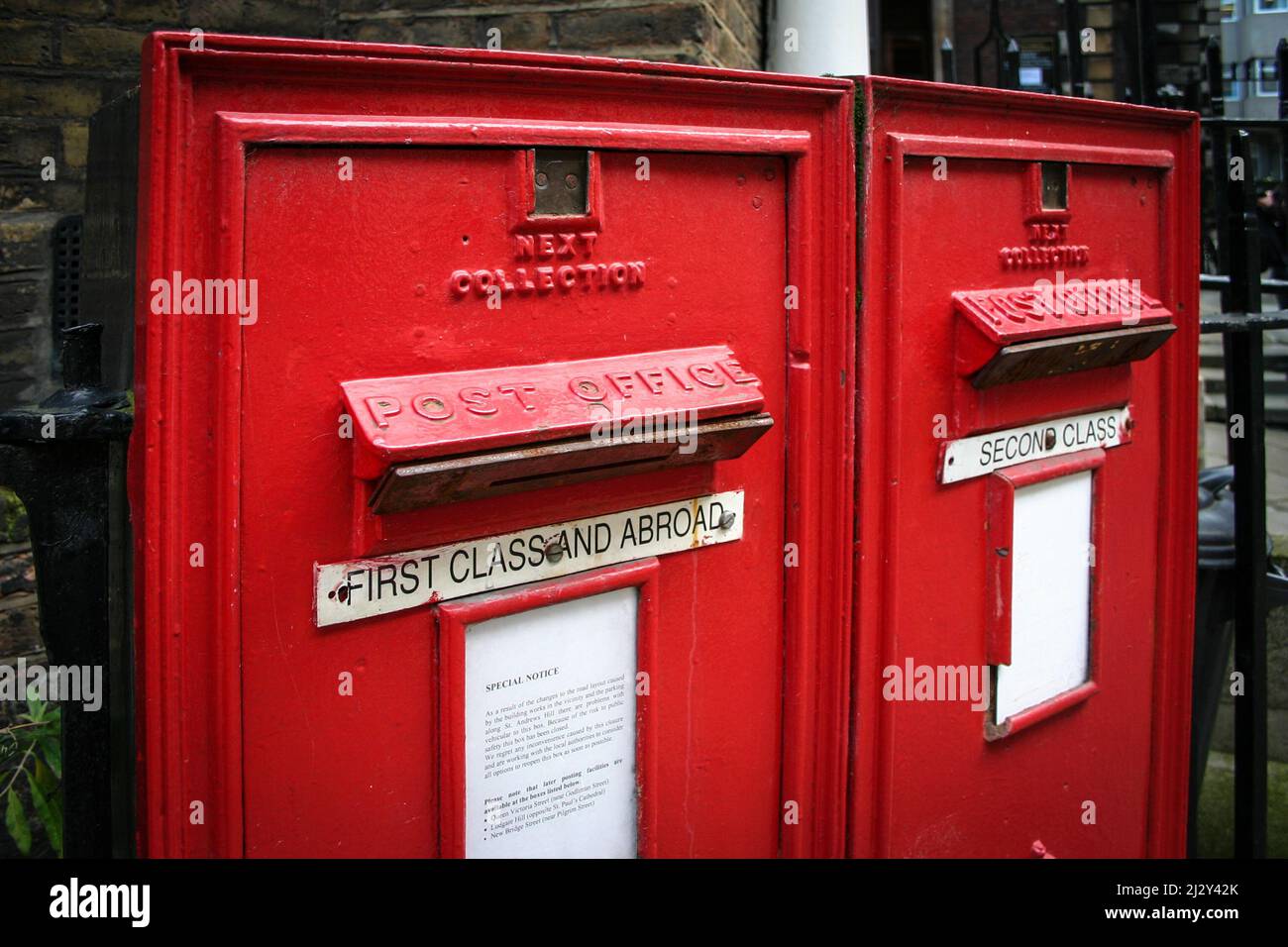 Old English post box. A pair of old-fashioned English post boxes with metal plates in place restricting post to regular letters only. Stock Photo