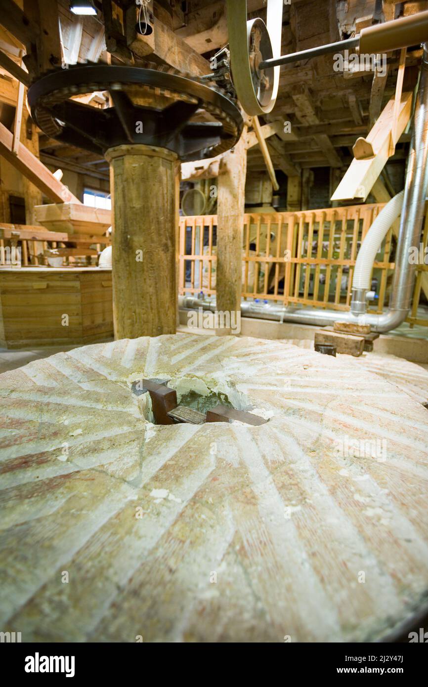 Old English flour mill. The millstone and mechanism from a historic old English water powered mill. Stock Photo