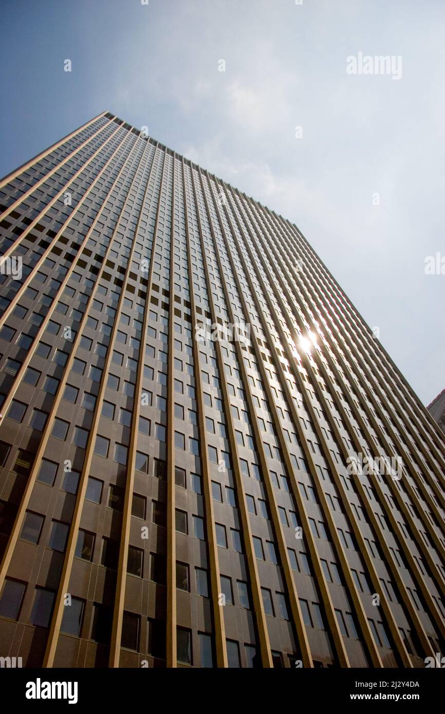 NYC architecture. A low angle view looking up a generic Manhattan skyscraper in the downtown financial district of New York City. Stock Photo