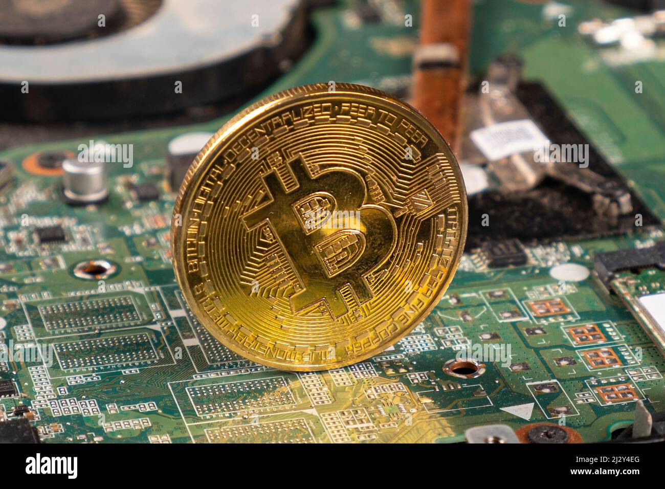 btc bitcoin gold coin on motherboard closeup. Stock Photo
