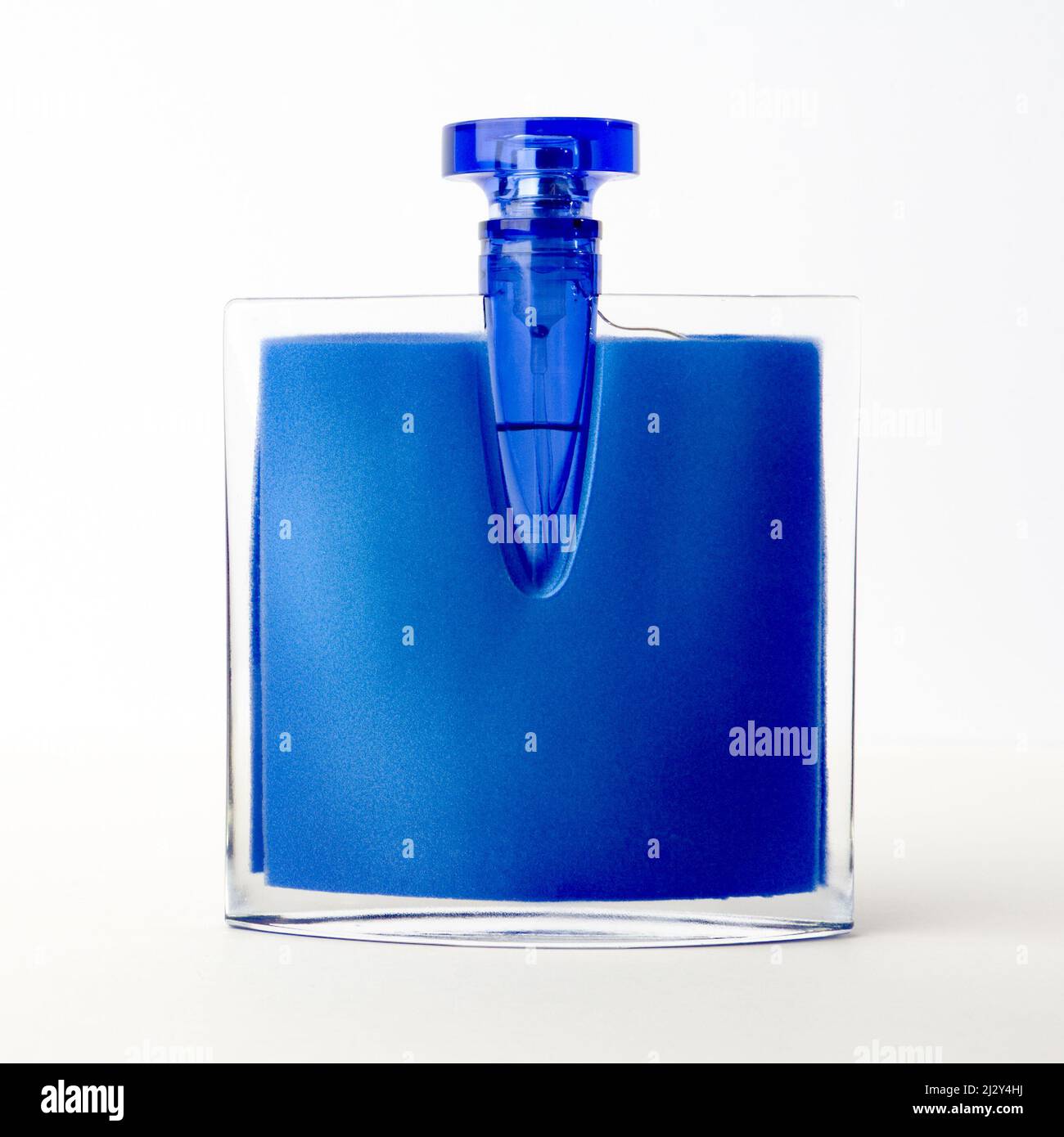 Blue Perfume Bottle. An unbranded perfume bottle isolated against a white background. Stock Photo