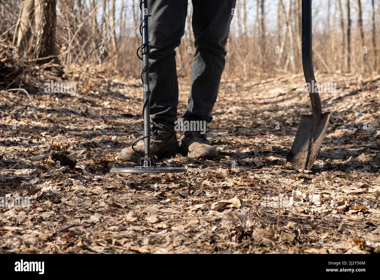 man search coins along old roads using a metal detector. Stock Photo
