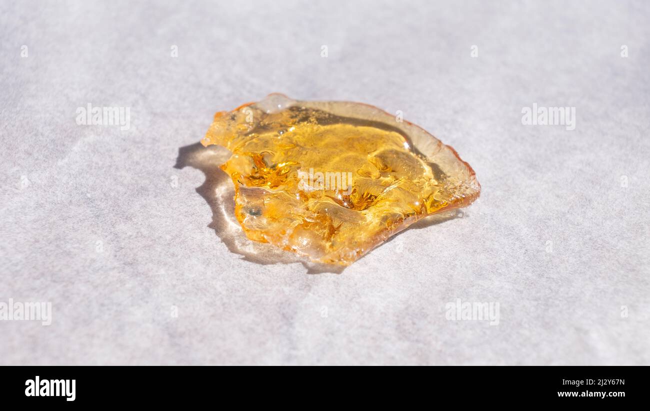 piece golden of cannabis wax, marijuana resin concentrate. Stock Photo