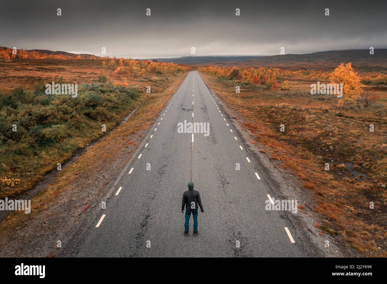 Person on the road of the Wilderness Road, on the Vildmarksvagen plateau in Jämtland in autumn in Sweden Stock Photo