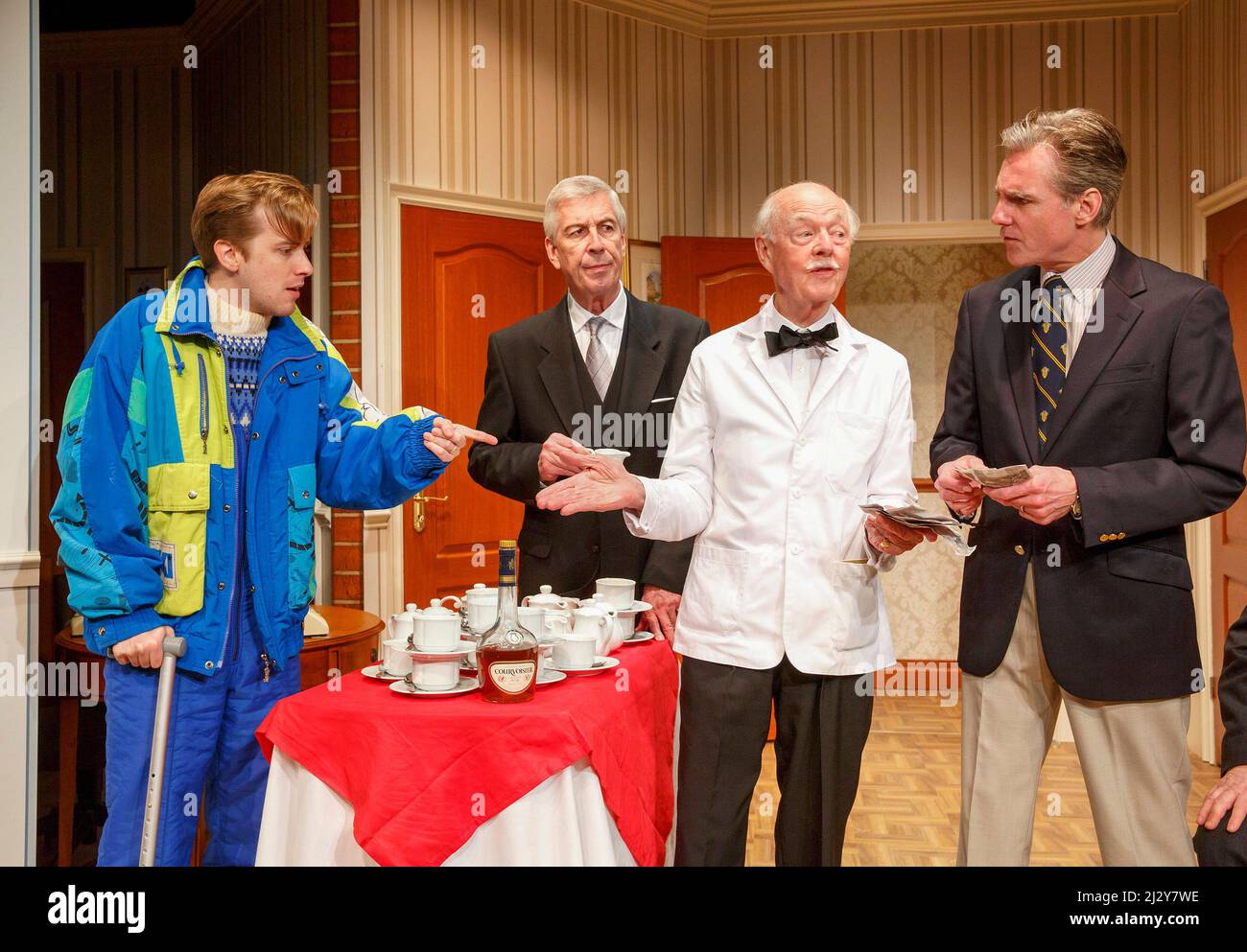 l-r: Tom Golding (Edward Bristow), Jeffrey Holland (Manager), Ray Cooney (Waiter), Michael Praed (Richard Willey) in TWO INTO ONE by Ray Cooney at the Menier Chocolate Factory, London SE1  19/03/2014 design: Julie Godfrey  lighting: Paul Anderson  director: Ray Cooney Stock Photo