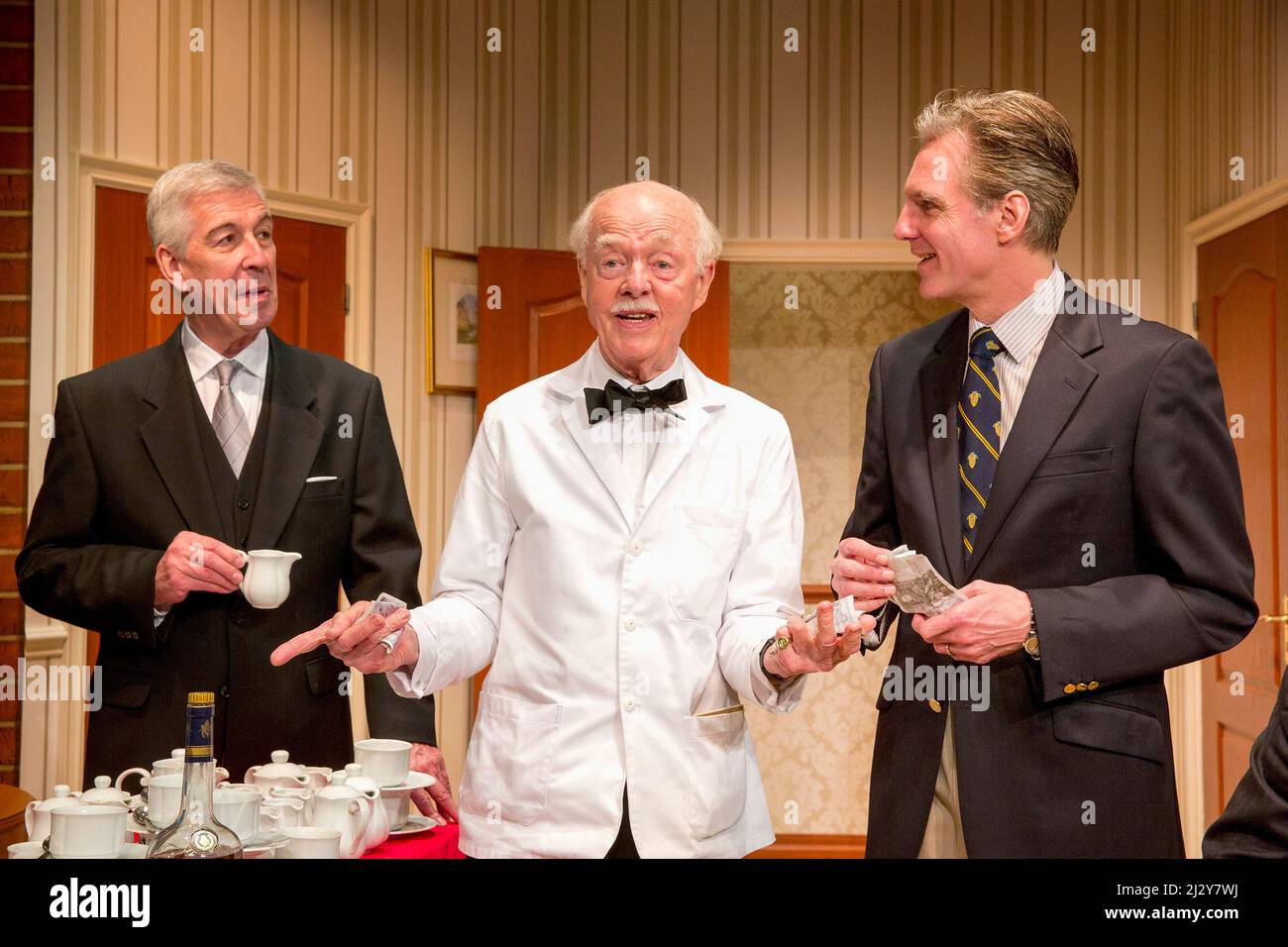 l-r: Jeffrey Holland (Manager), Ray Cooney (Waiter), Michael Praed (Richard Willey) in TWO INTO ONE by Ray Cooney at the Menier Chocolate Factory, London SE1  19/03/2014 design: Julie Godfrey  lighting: Paul Anderson  director: Ray Cooney Stock Photo