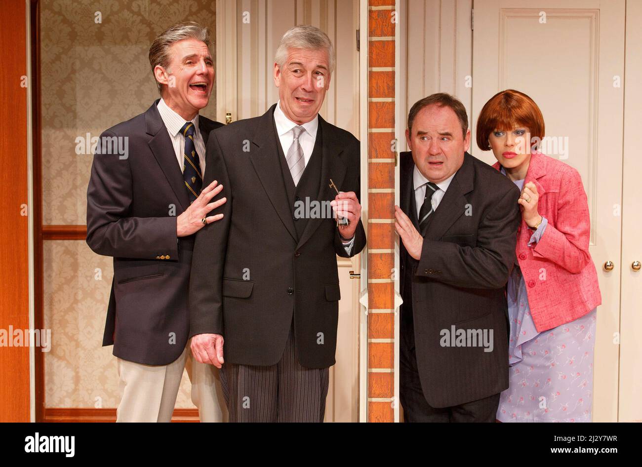 l-r: Michael Praed (Richard Willey), Jeffrey Holland (Manager), Nick Wilton (George Pigden), Kelly Adams (Jennifer Bristow) in TWO INTO ONE by Ray Cooney at the Menier Chocolate Factory, London SE1  19/03/2014  design: Julie Godfrey  lighting: Paul Anderson  director: Ray Cooney Stock Photo
