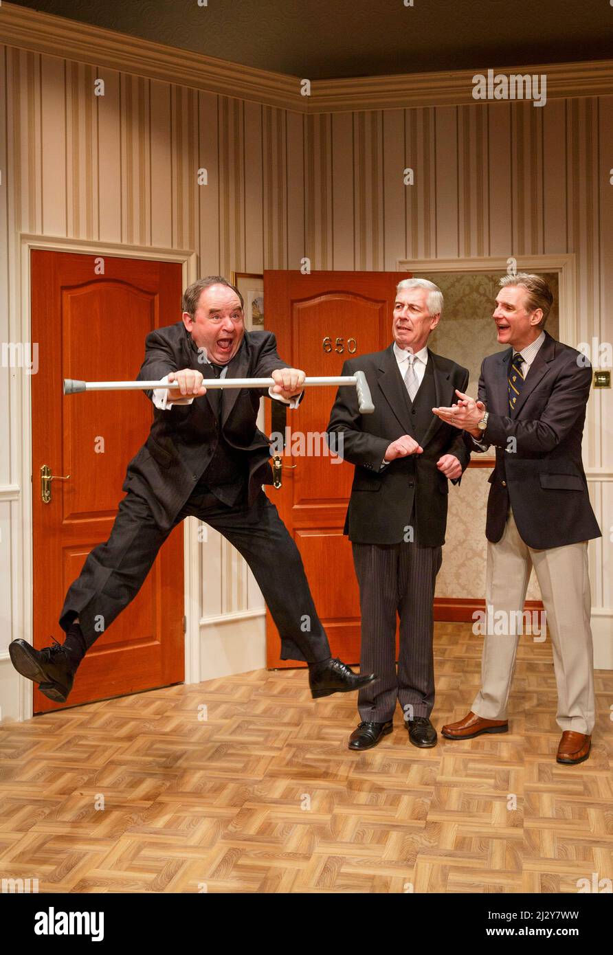 l-r: Nick Wilton (George Pigden), Jeffrey Holland (Manager), Michael Praed (Richard Willey) in TWO INTO ONE by Ray Cooney at the Menier Chocolate Factory, London SE1  19/03/2014 design: Julie Godfrey  lighting: Paul Anderson  director: Ray Cooney Stock Photo