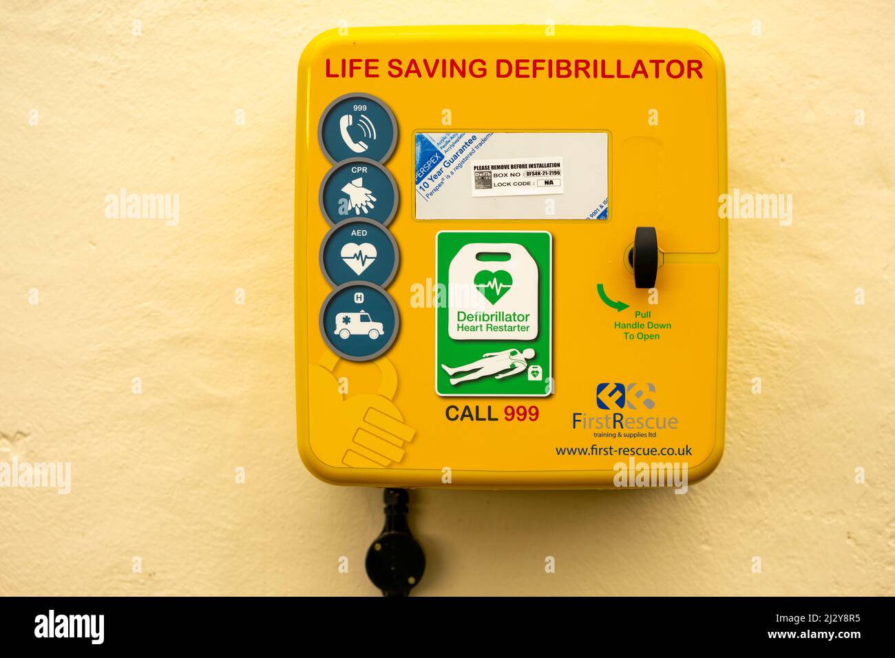 A defibrillator attached to the wall of a community building in Cardiff, Wales, United Kingdom. Stock Photo