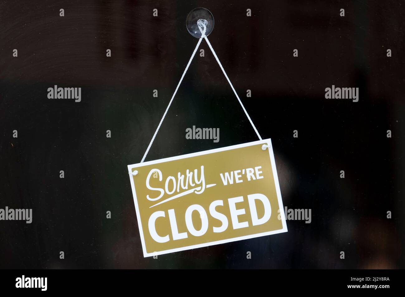 A sign on the window of a small business saying Òsorry weÕre closedÓ. Stock Photo