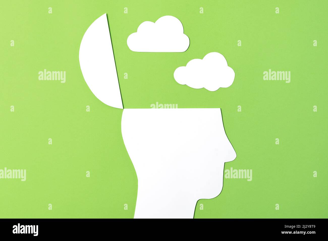 Dark Thoughts Concept, Paper Cut out Open head with paper cut out clouds above Stock Photo
