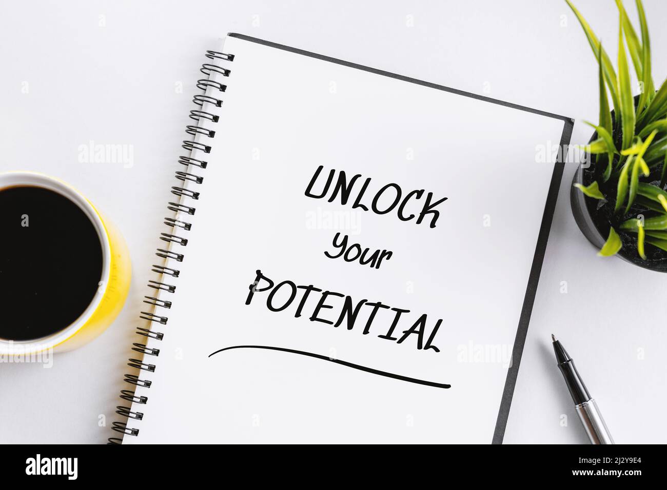 Notebook With Inspirational Quote . Unlock Your Potential. Stock Photo