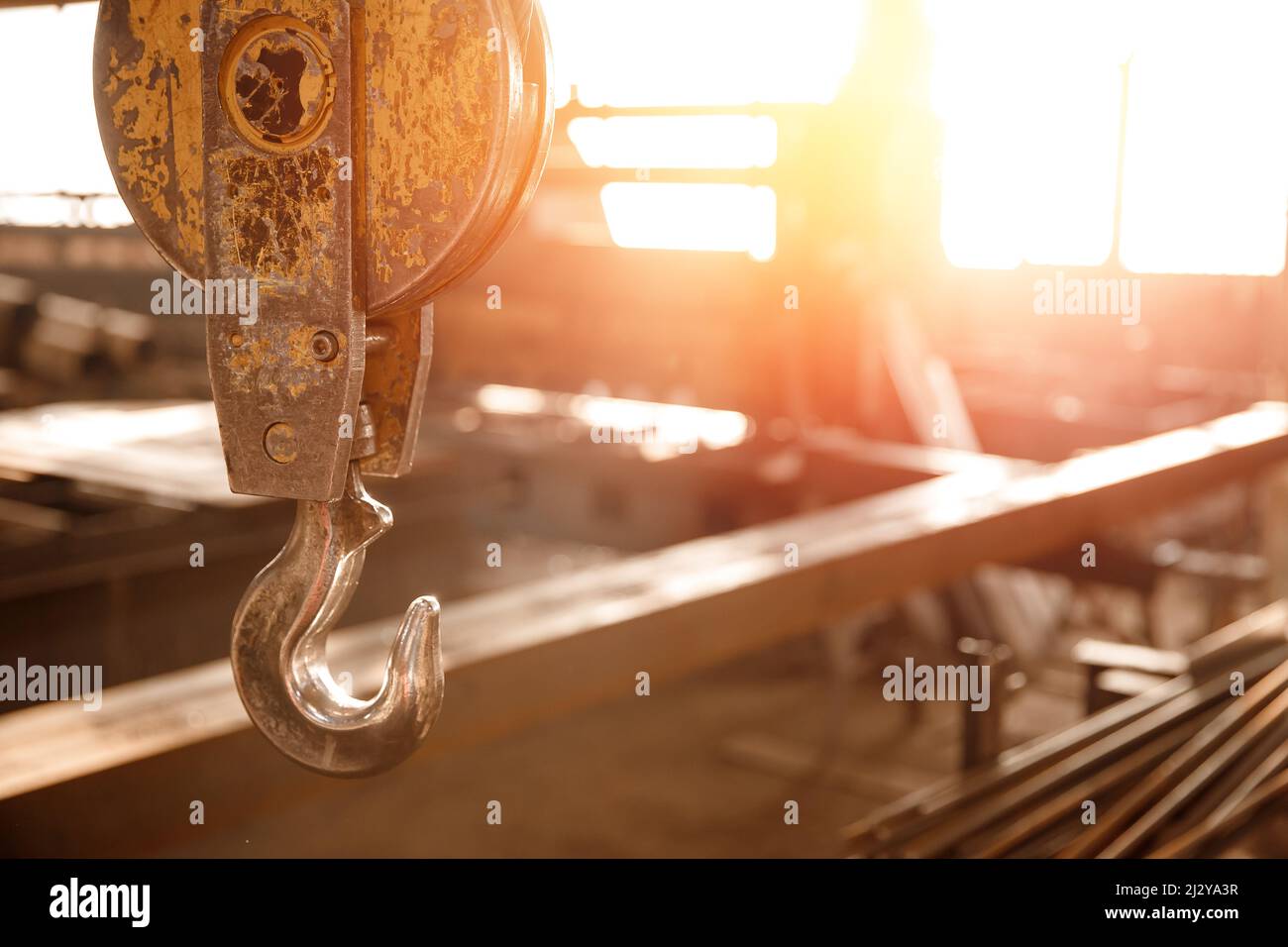 Industrial overhead beam crane lift background factory sunlight. Stock Photo