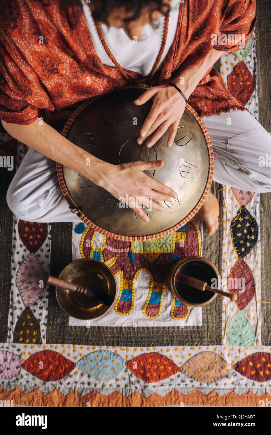 Closeup of a man's hand playing a modern musical instrument, the orion