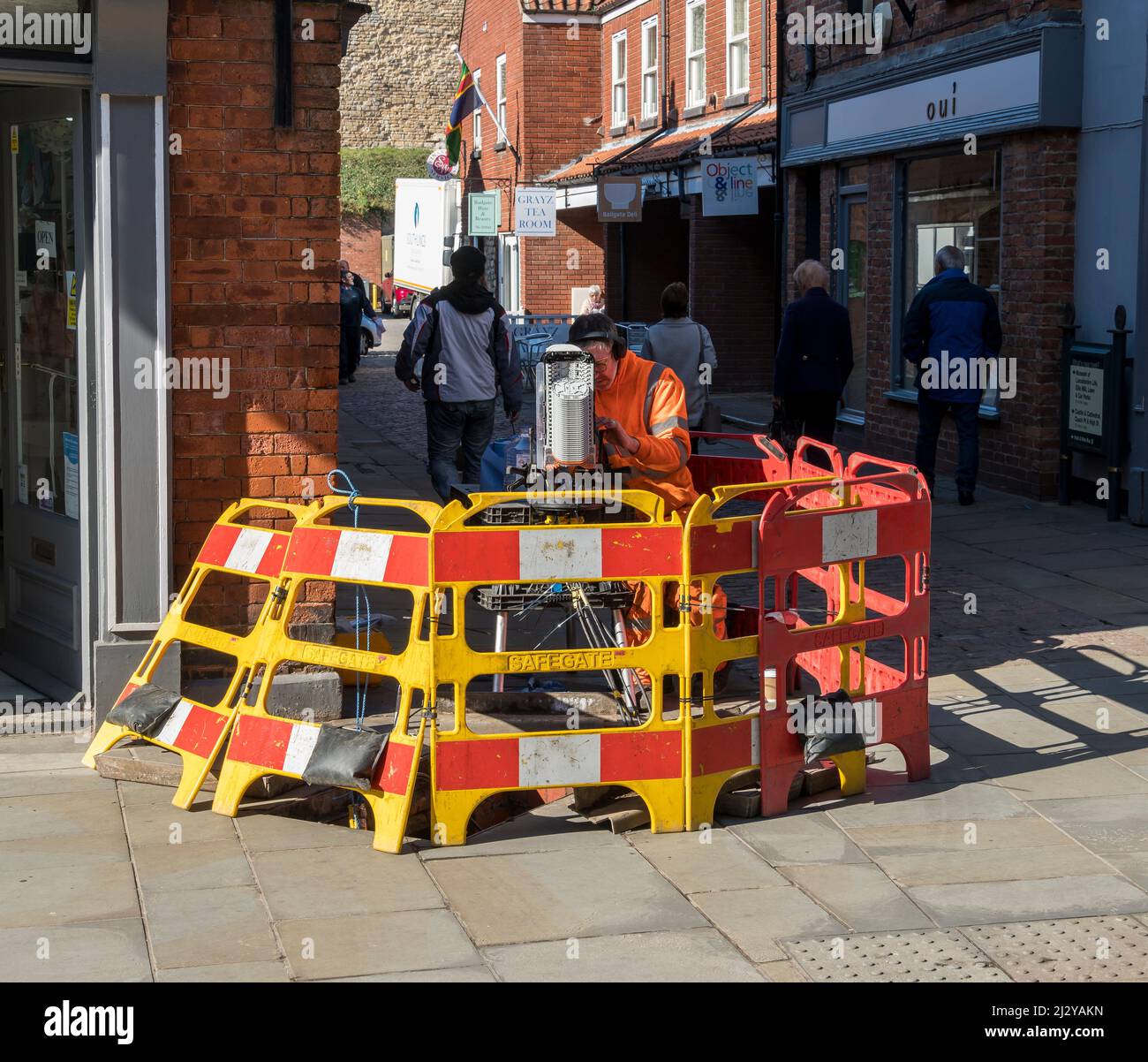 An Openreach engineer working on the provider's underground full fibre network. Bailgate Lincoln City 2022 Stock Photo