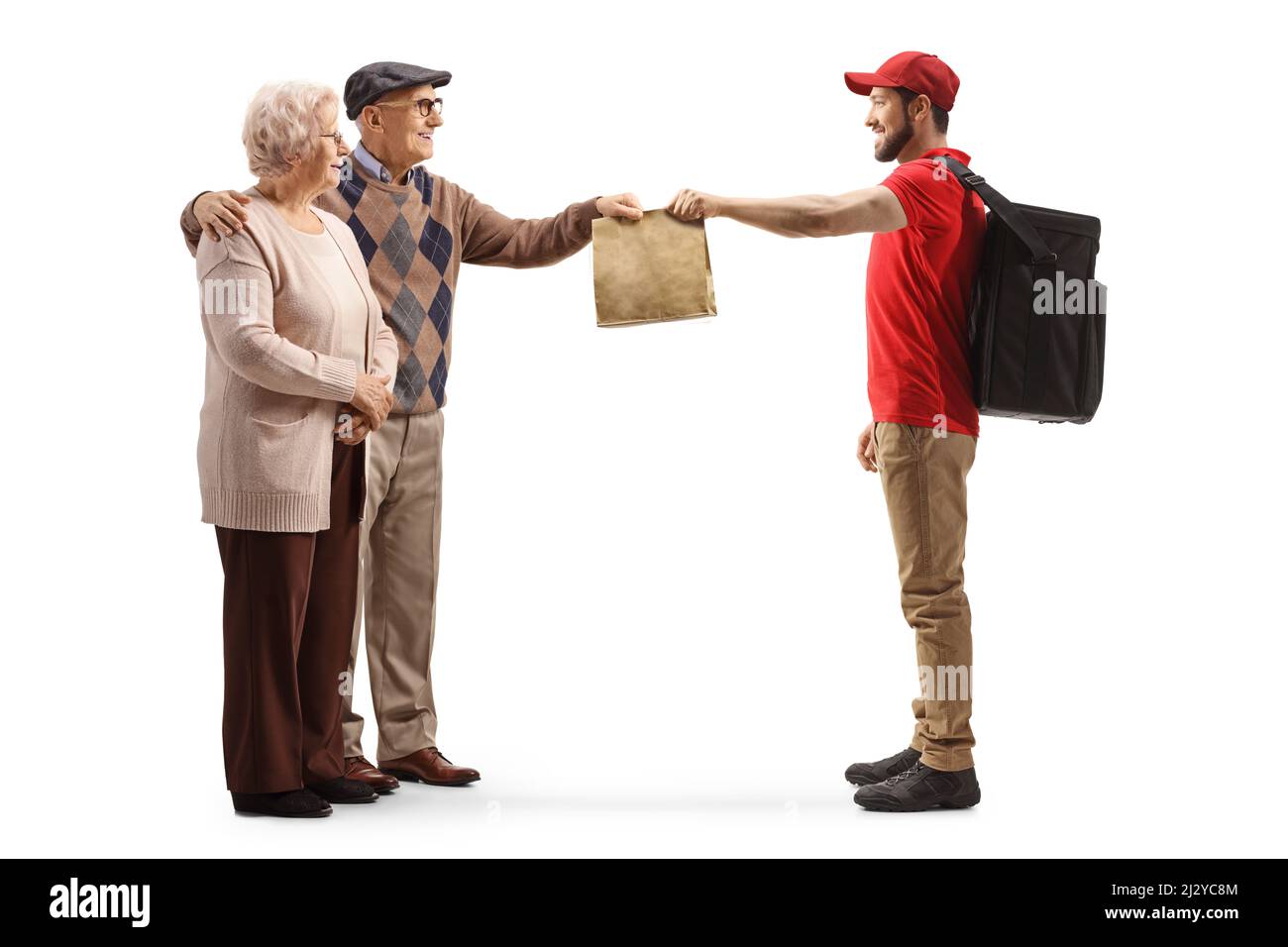 Full length profile shot of a guy delivering takeaway food bag to an elderly couple isolated on white background Stock Photo