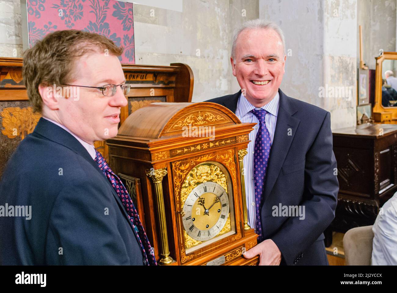 Belfast, Northern Ireland. 13th April 2008.  Allstate's Bro McFerran holds an antique clock as the Antiques Roadshow is filmed at the Titanic Drawing Office, Belfast Stock Photo