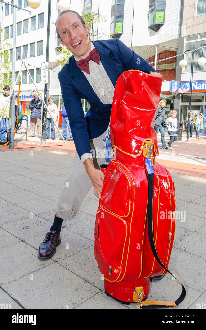 Belfast, Northern Ireland. 3rd May 2008.  A Street performer performs to an audience outside Castle Court Shopping Centre. Stock Photo