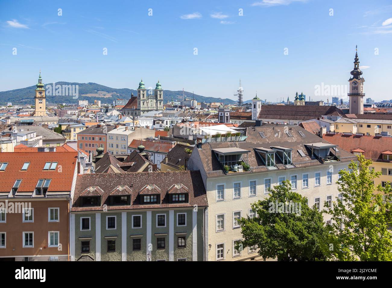 View of the city of Linz from the terraces of Schlossmuseum, showing historic buildings and the Danube River.