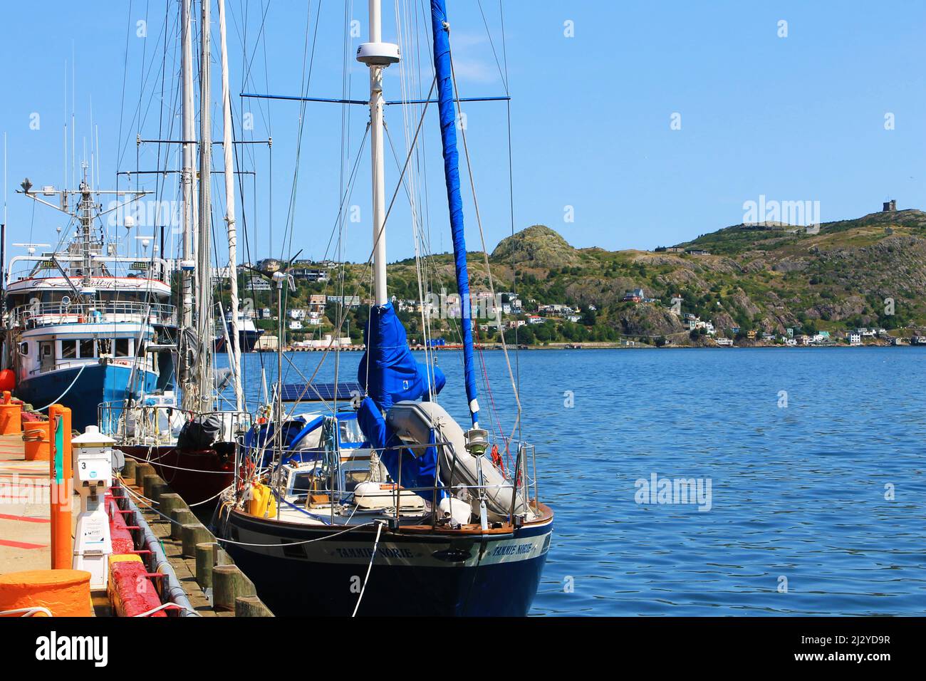 Ships and yachts moored to the pier, St. John's Harbour. Stock Photo