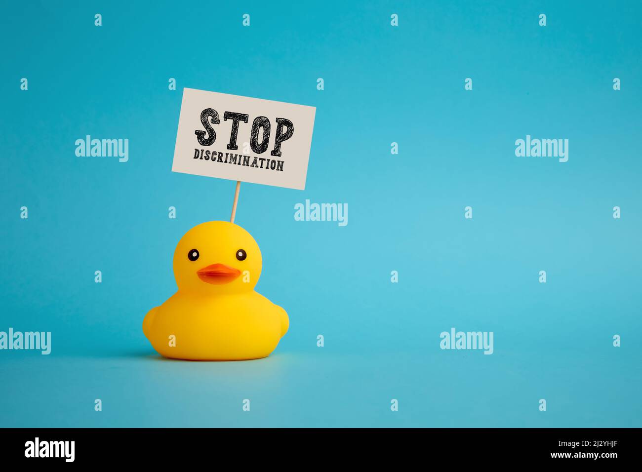 Rubber duck carries a signboard with the word stop discrimination. Political activism against discrimination concept. Stock Photo