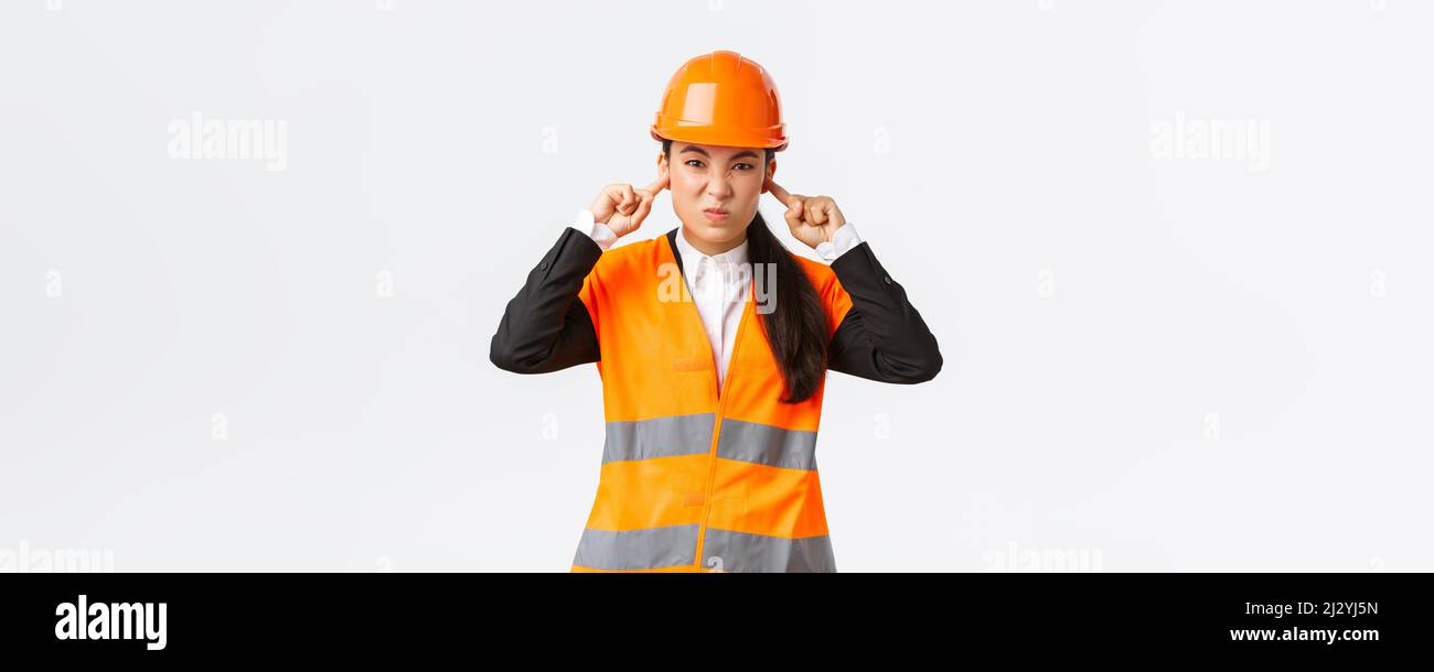Engineer Shut Up Bothered and displeased asian female chief engineer shut ears and ...