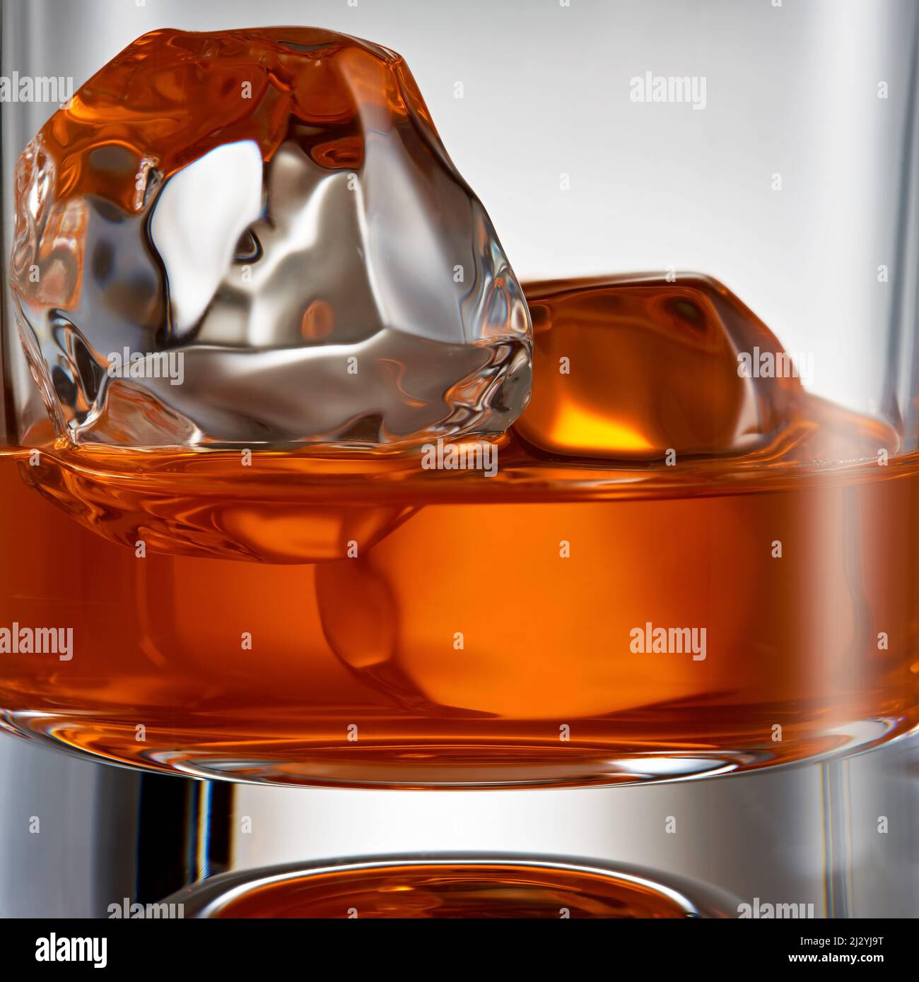 blended scotch whiskey served in a short glass with a large ice cube  isolated on a white background Stock Photo - Alamy
