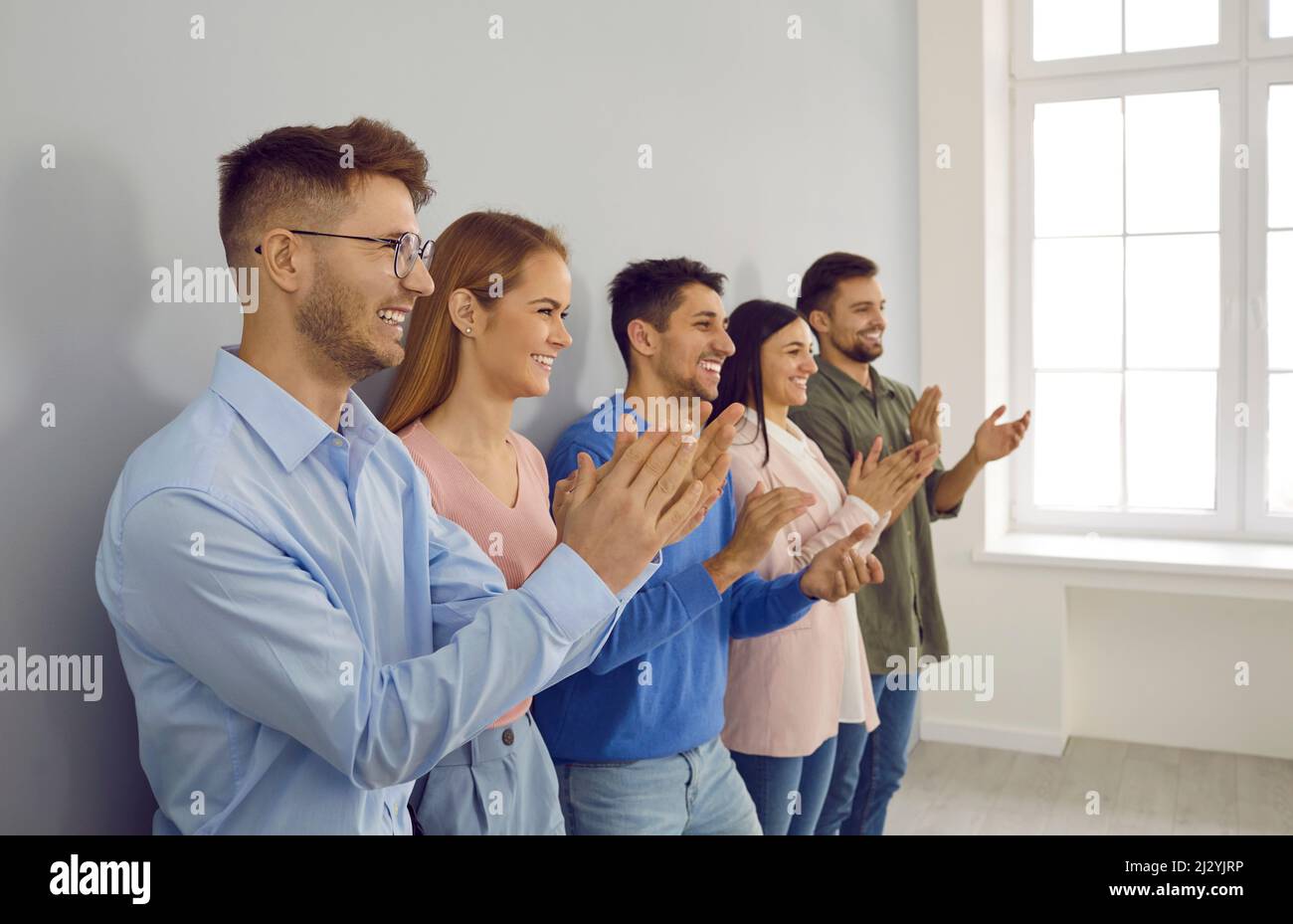 Happy businesspeople clap hands show appreciation Stock Photo