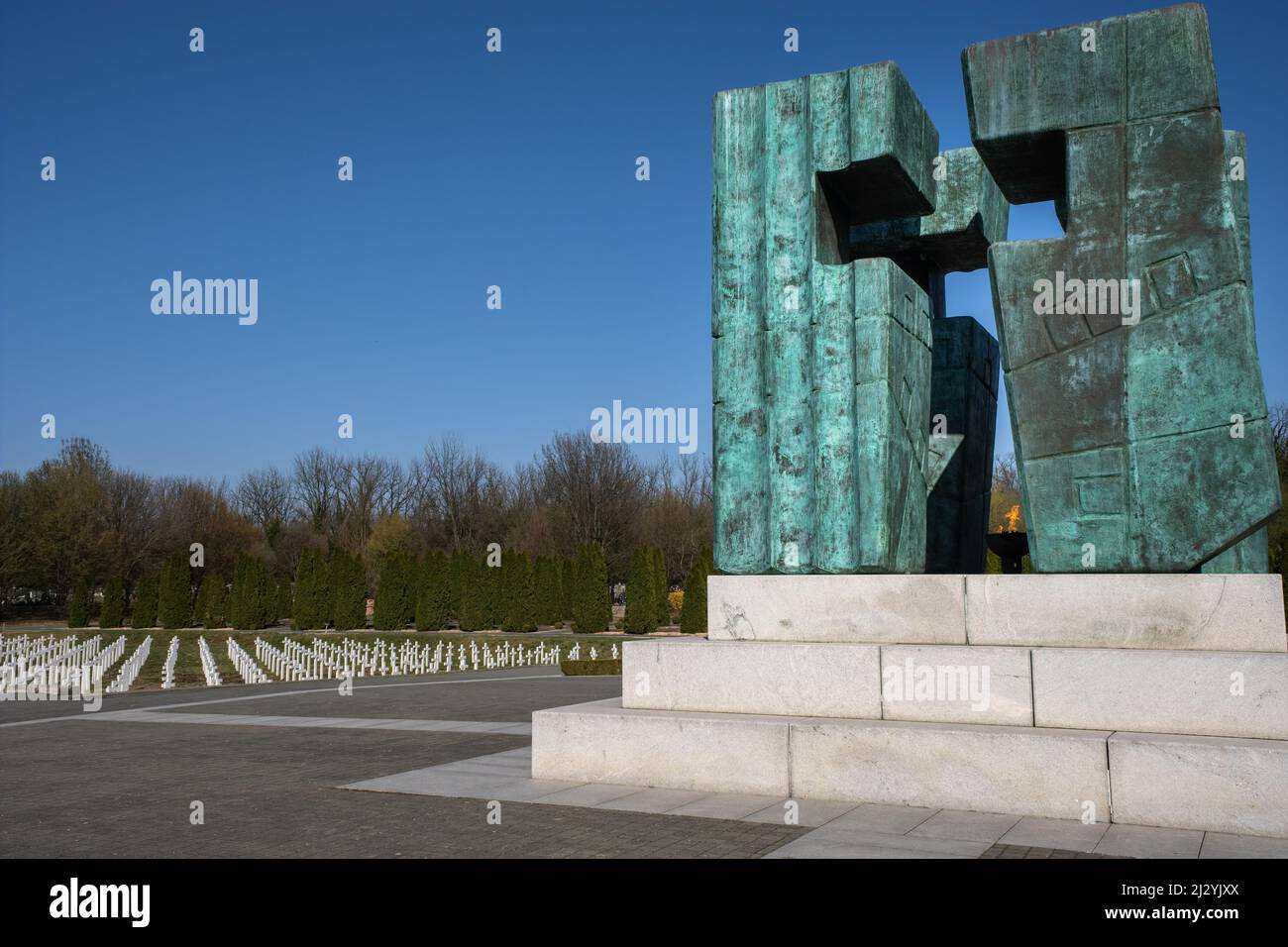 Vukovar, Croatia - March 28, 2022: Vukovar Memorial Cemetery. 938 white marble crosses, one in memory of each victim. The monument is made of patinate Stock Photo