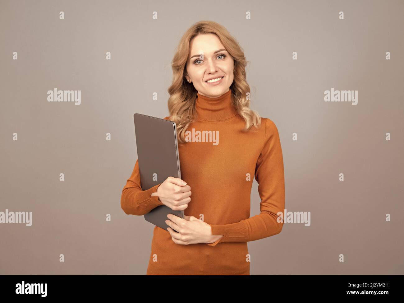 network administrator hold computer. friendly looking office manager