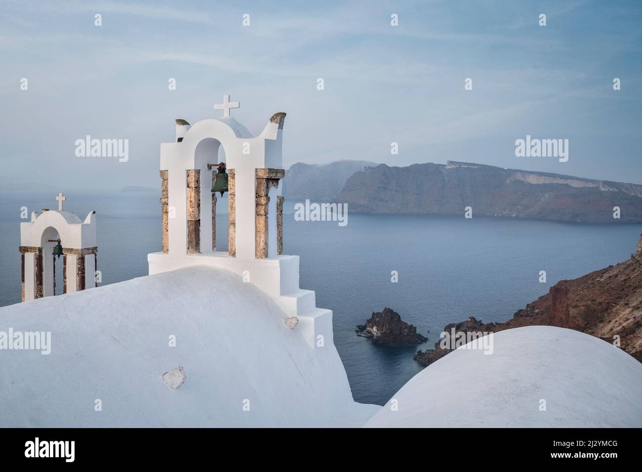 Church on the steep coast of Oia, view of the caldera of Santorini, Santorin, Cyclades, Aegean Sea, Mediterranean Sea, Greece, Europe Stock Photo