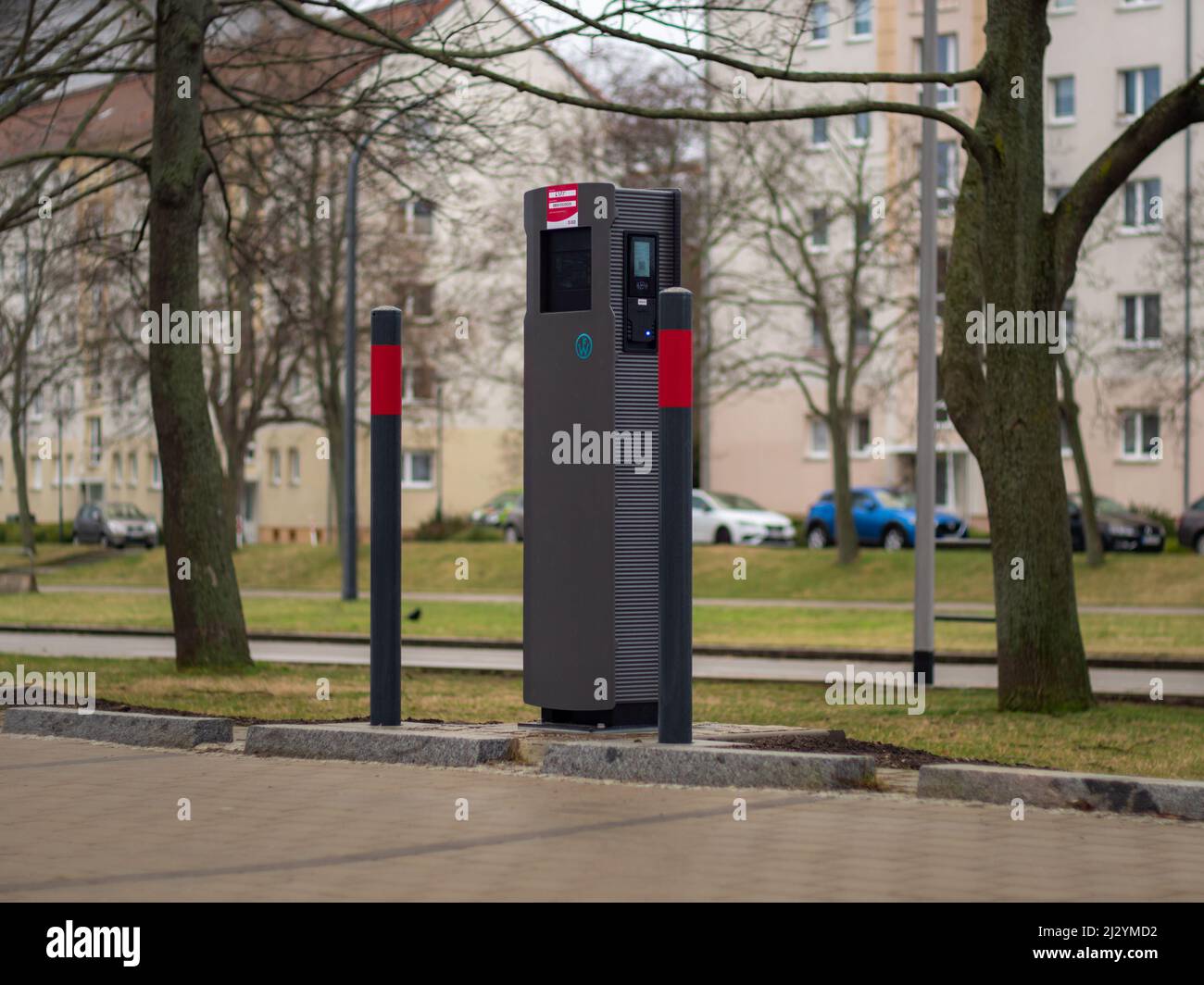 Charging station for an electric car on a parking lot. Empty space to park and charge an electric vehicle. New device in the city for zero emission. Stock Photo