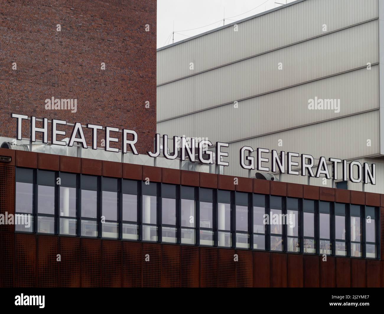 Theater Junge Generation lettering on an old industrial building. The theater is producing culture for a young audience. The facade is in rusty steel. Stock Photo