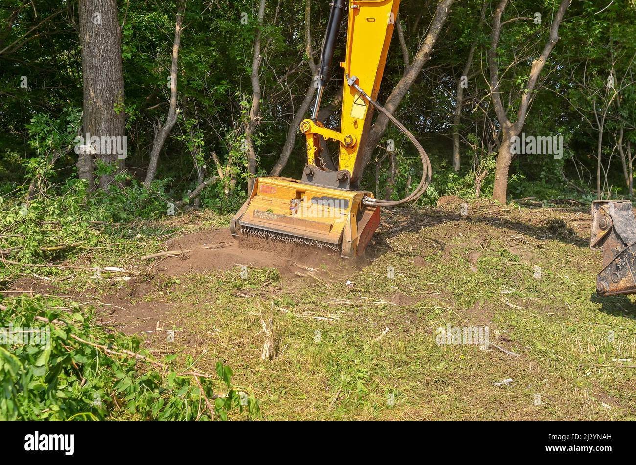 Roadside cleaning device. Mulcher. Processing of branches and vegetation Stock Photo