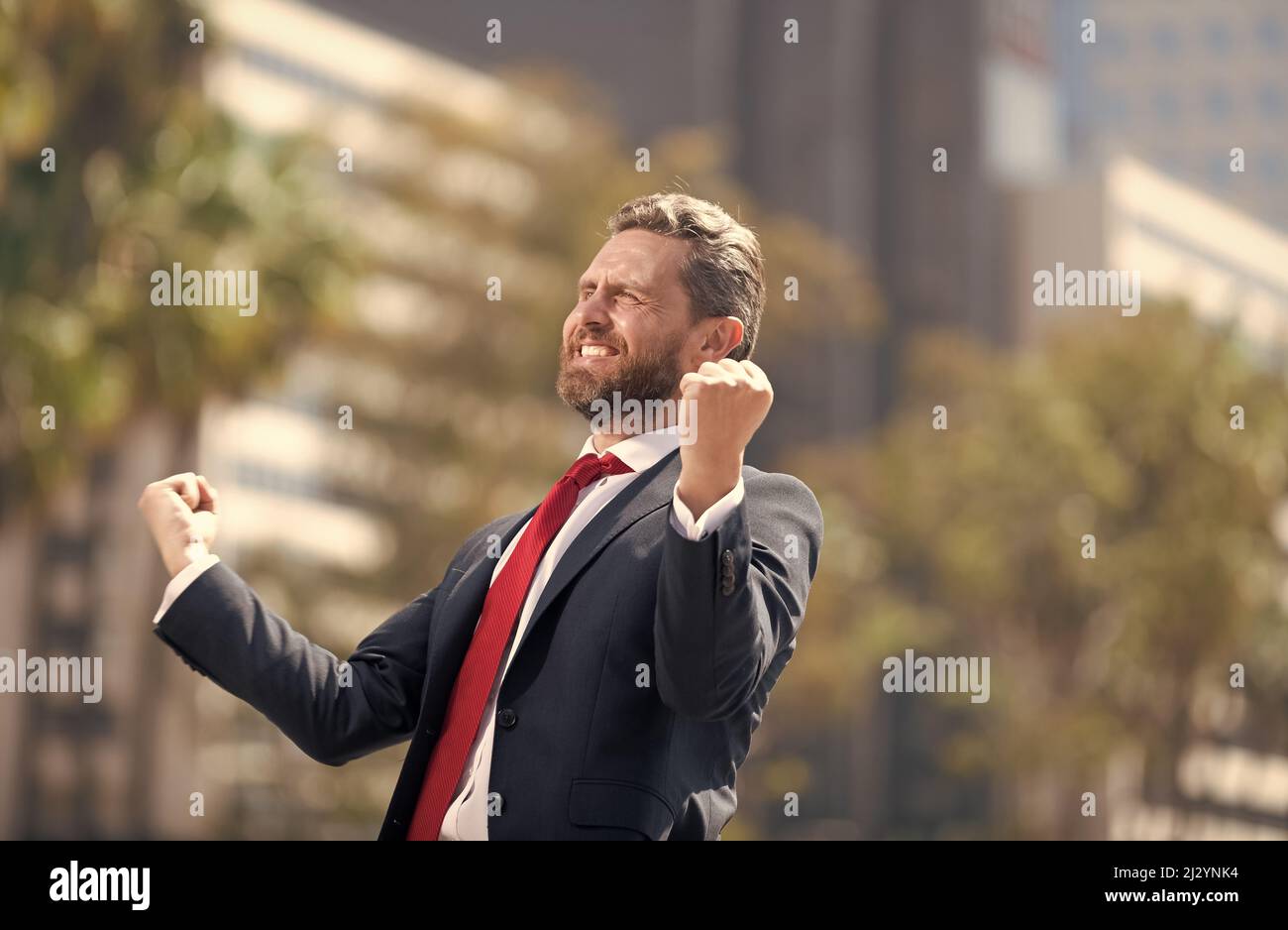 happy man businessman in suit and red tie celebrating business success ...